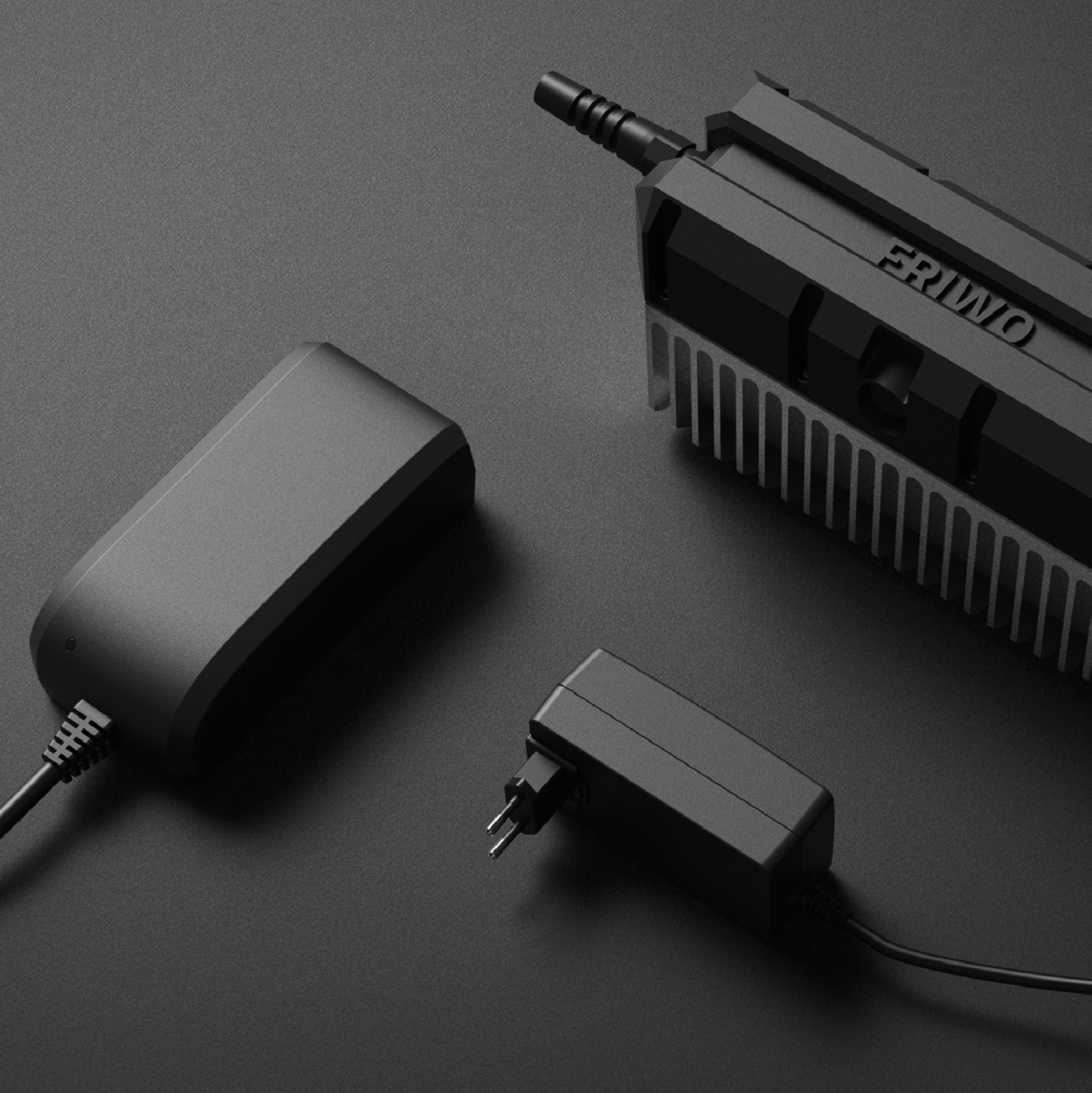 black chargers are laying on a black surface