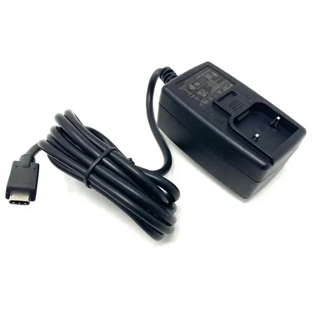 A black power supply is sitting on a white surface
