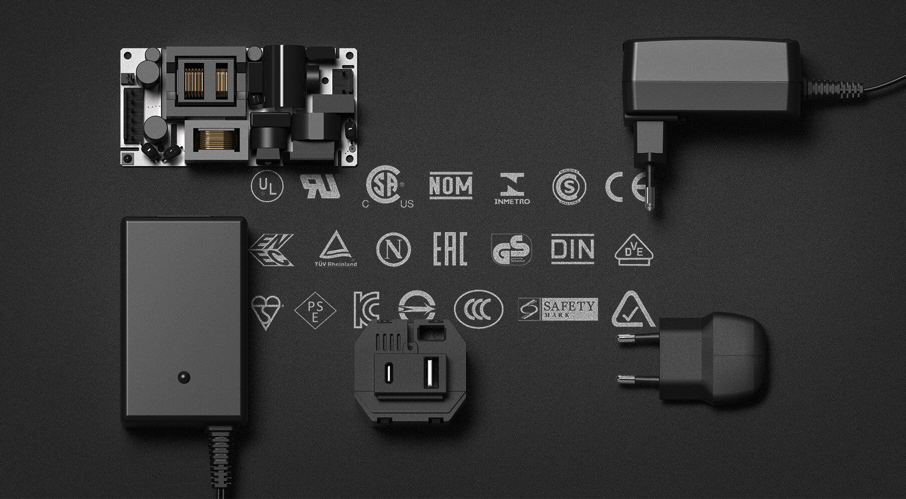 A bunch of different types of power supplies on a black surface with global standards printed on the surface