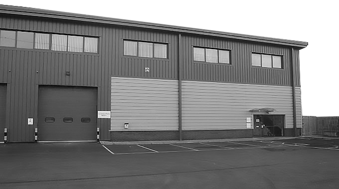 A black and white drawing of a large building with a garage door.