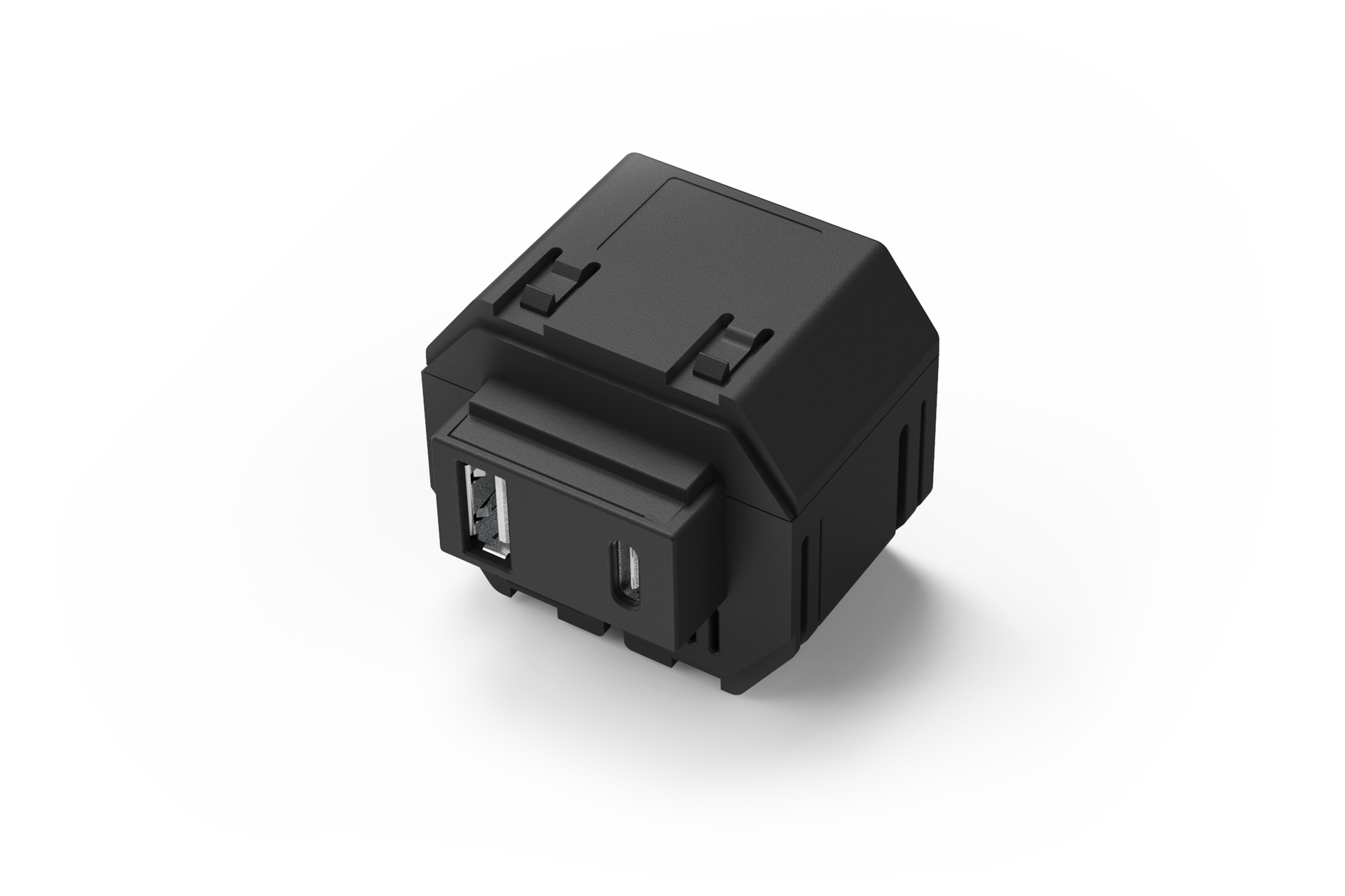 A black in wall power supply with two holes in it is sitting on a white surface.