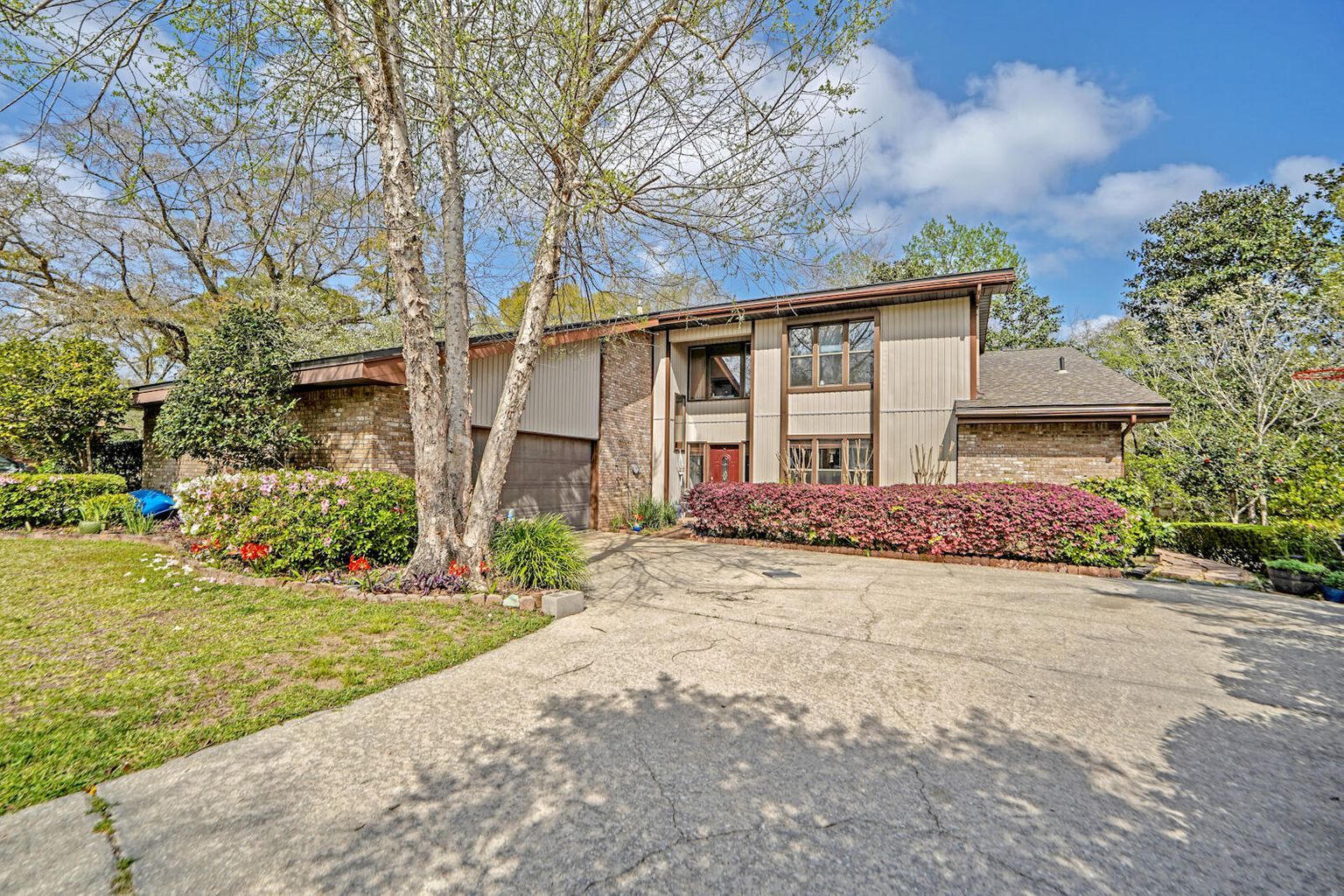 Exterior Photo of a House with a tree in the front yard