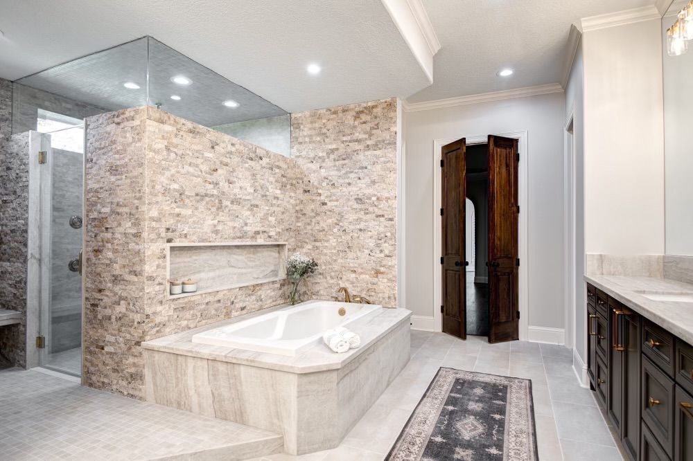 A bathroom with a bathtub and a walk in shower.