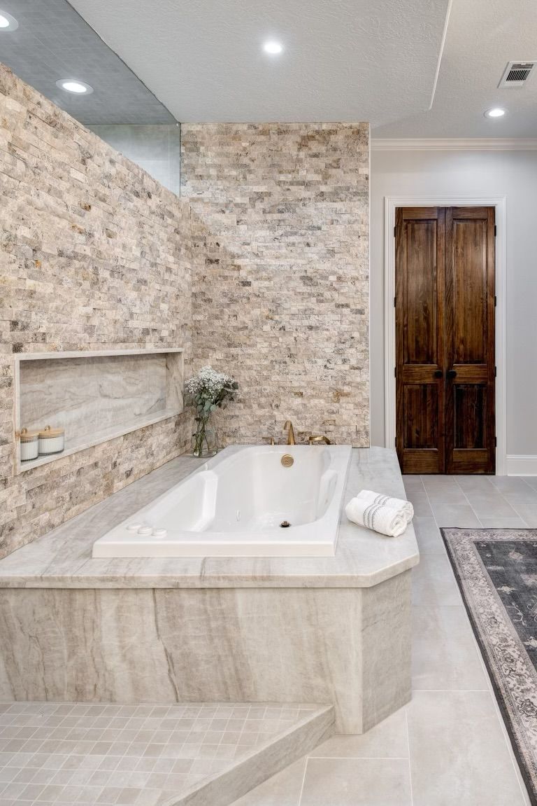 There is a bathtub in the middle of the bathroom.