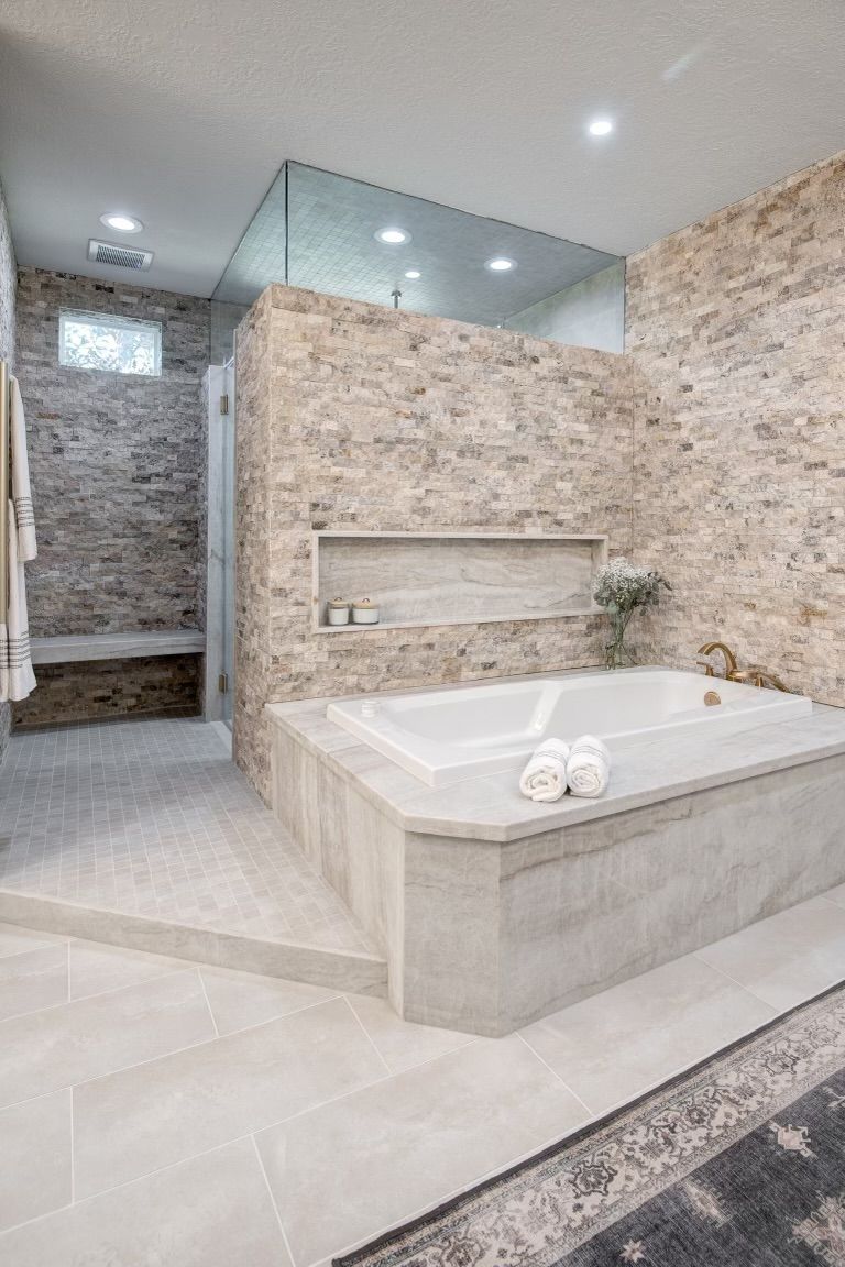 A bathroom with a bathtub and a walk in shower.