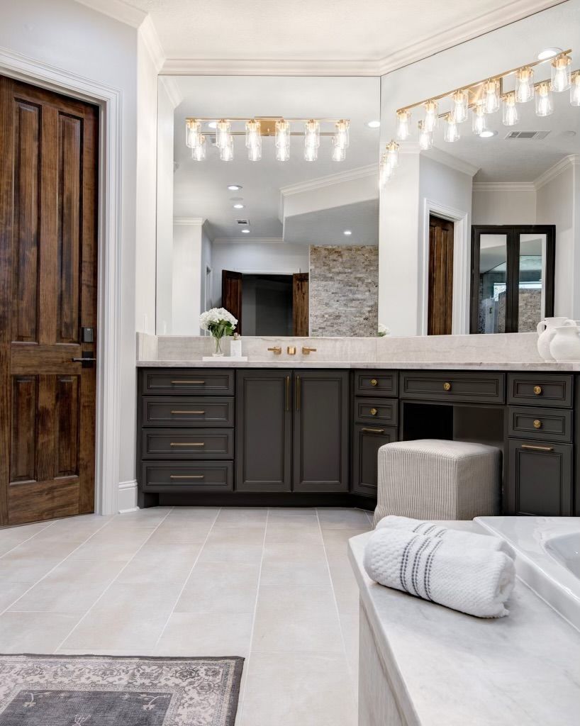 A bathroom with a large mirror and a bathtub.