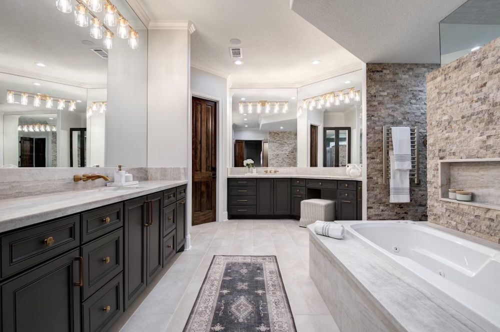 A bathroom with two sinks , a tub , and a rug.