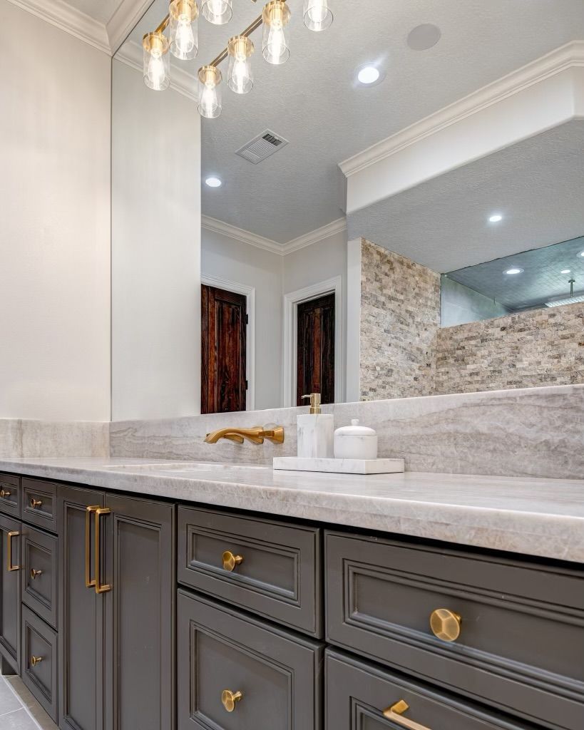 A bathroom with two sinks and a large mirror.