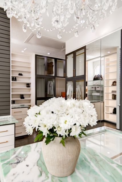 A vase of white flowers sits on a table in a closet