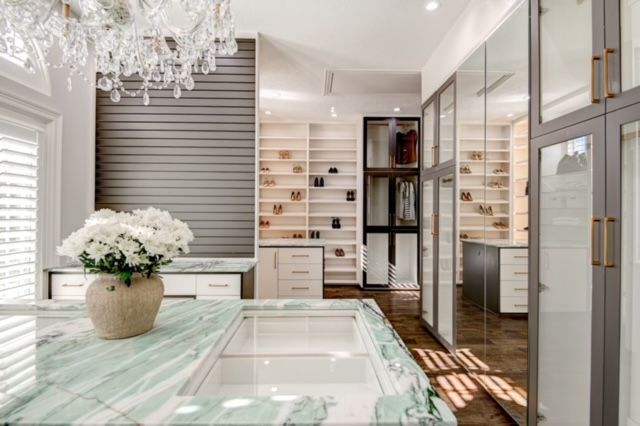 A kitchen with a sink and a vase of flowers on the counter.