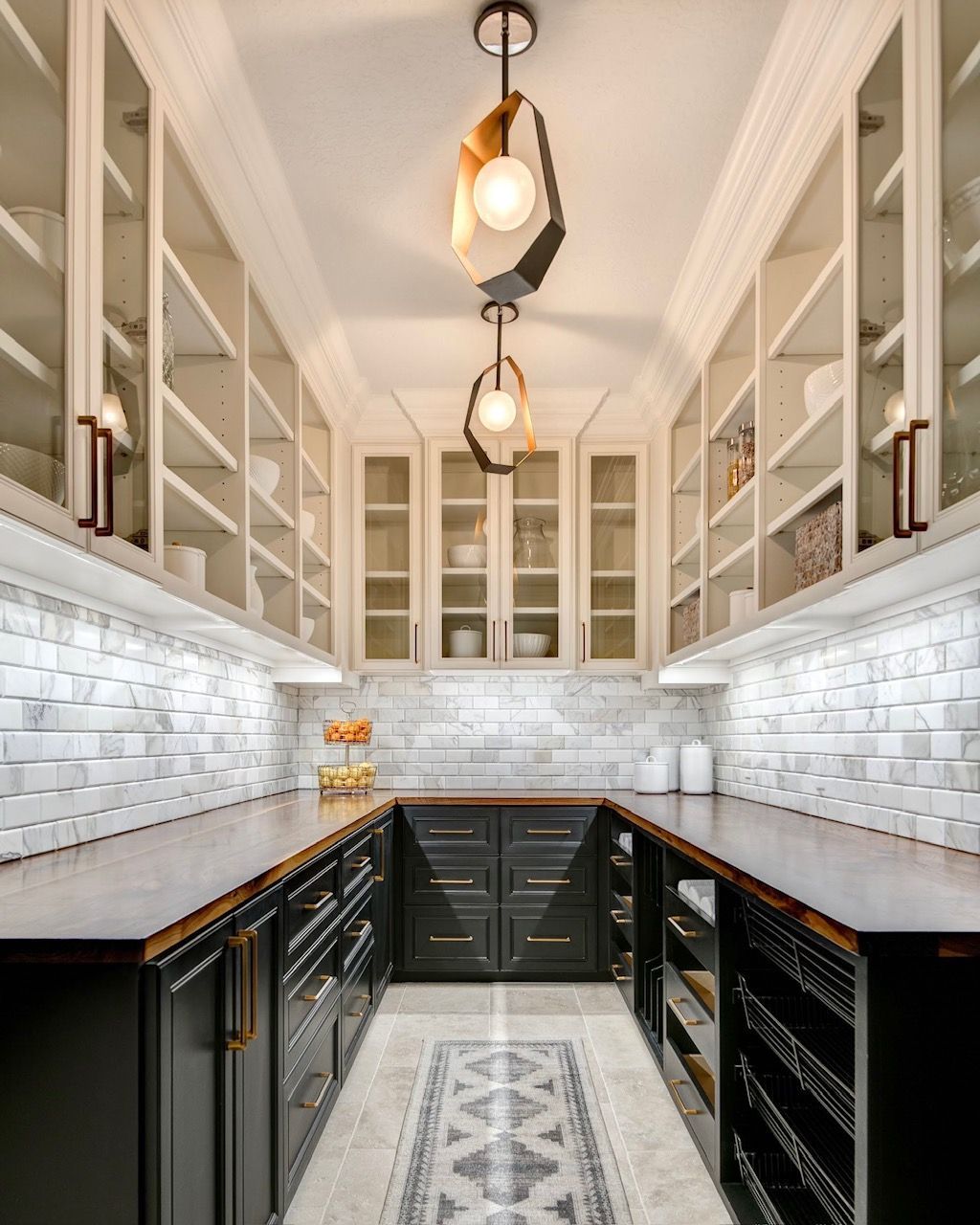 A kitchen with a lot of cabinets and a ceiling light.