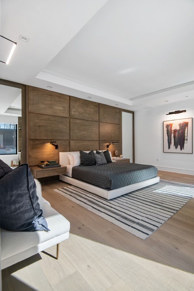 A bedroom with a large bed and a rug