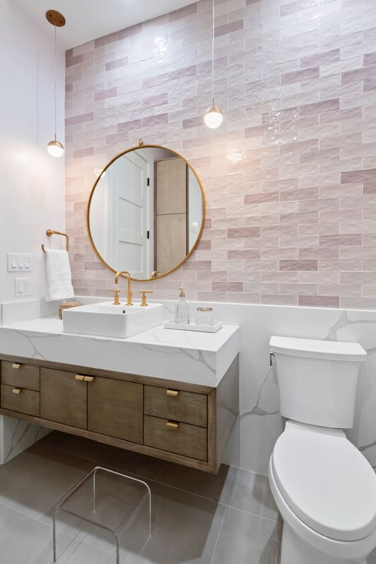 A bathroom with a sink , toilet and mirror.