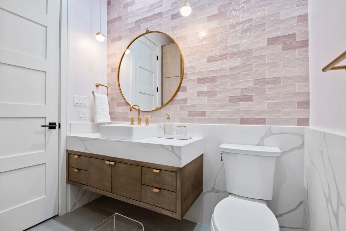A bathroom with a sink , toilet and mirror.