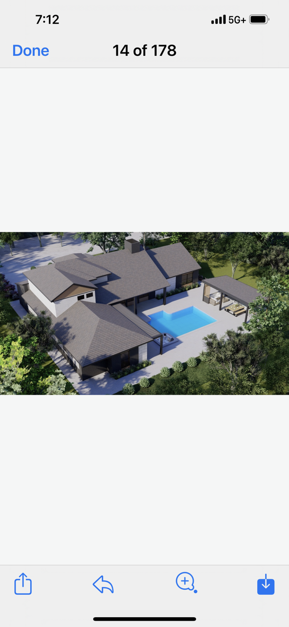 An aerial view of a house with a pool in the backyard.