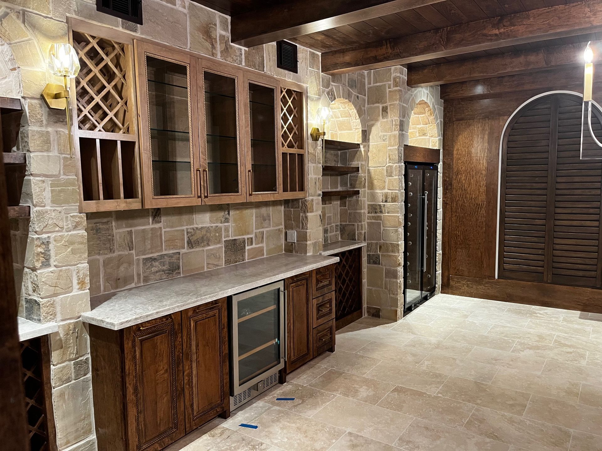 A kitchen with wooden cabinets and a wine cooler.