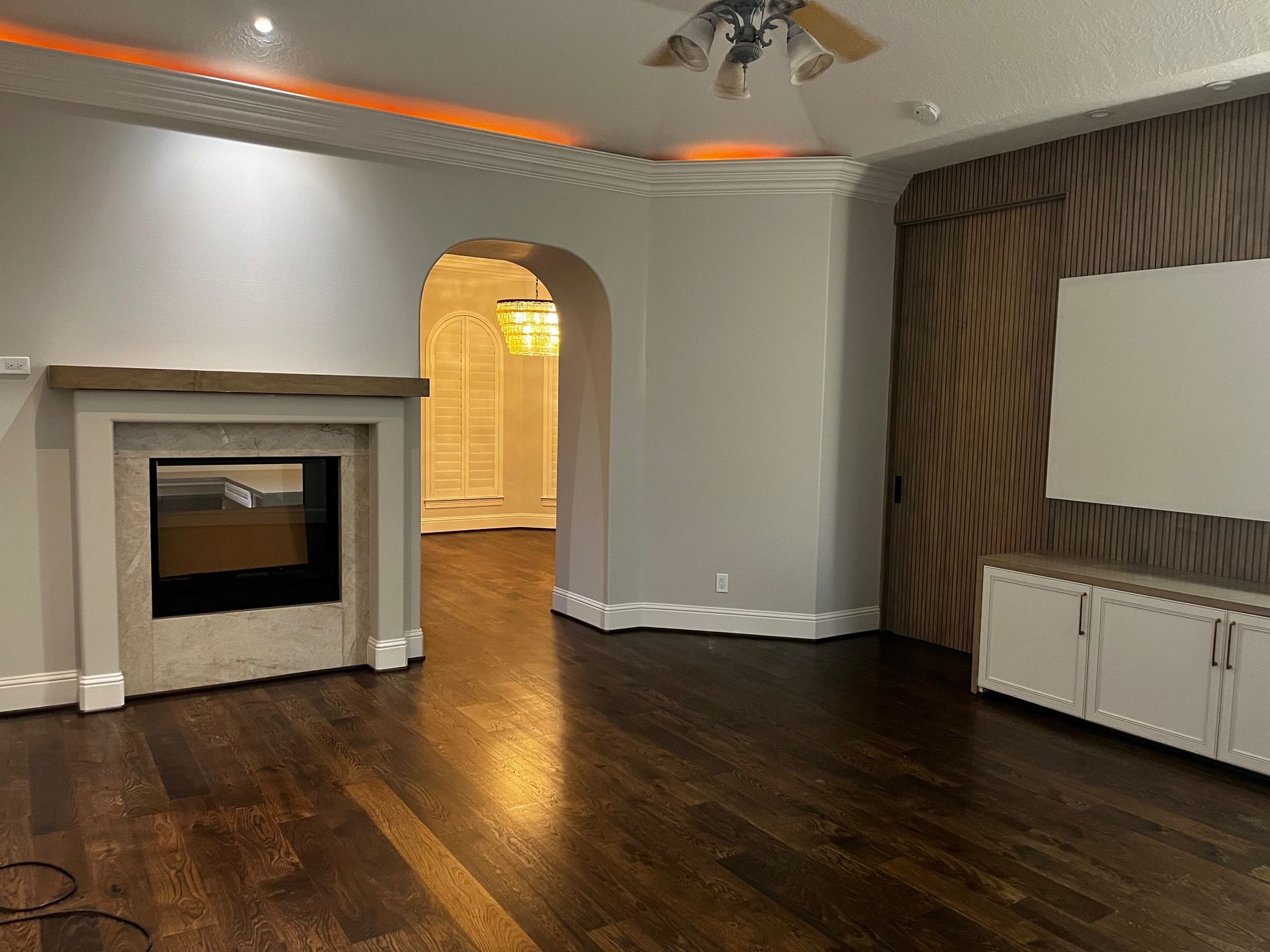 A living room with a fireplace and a flat screen tv.
