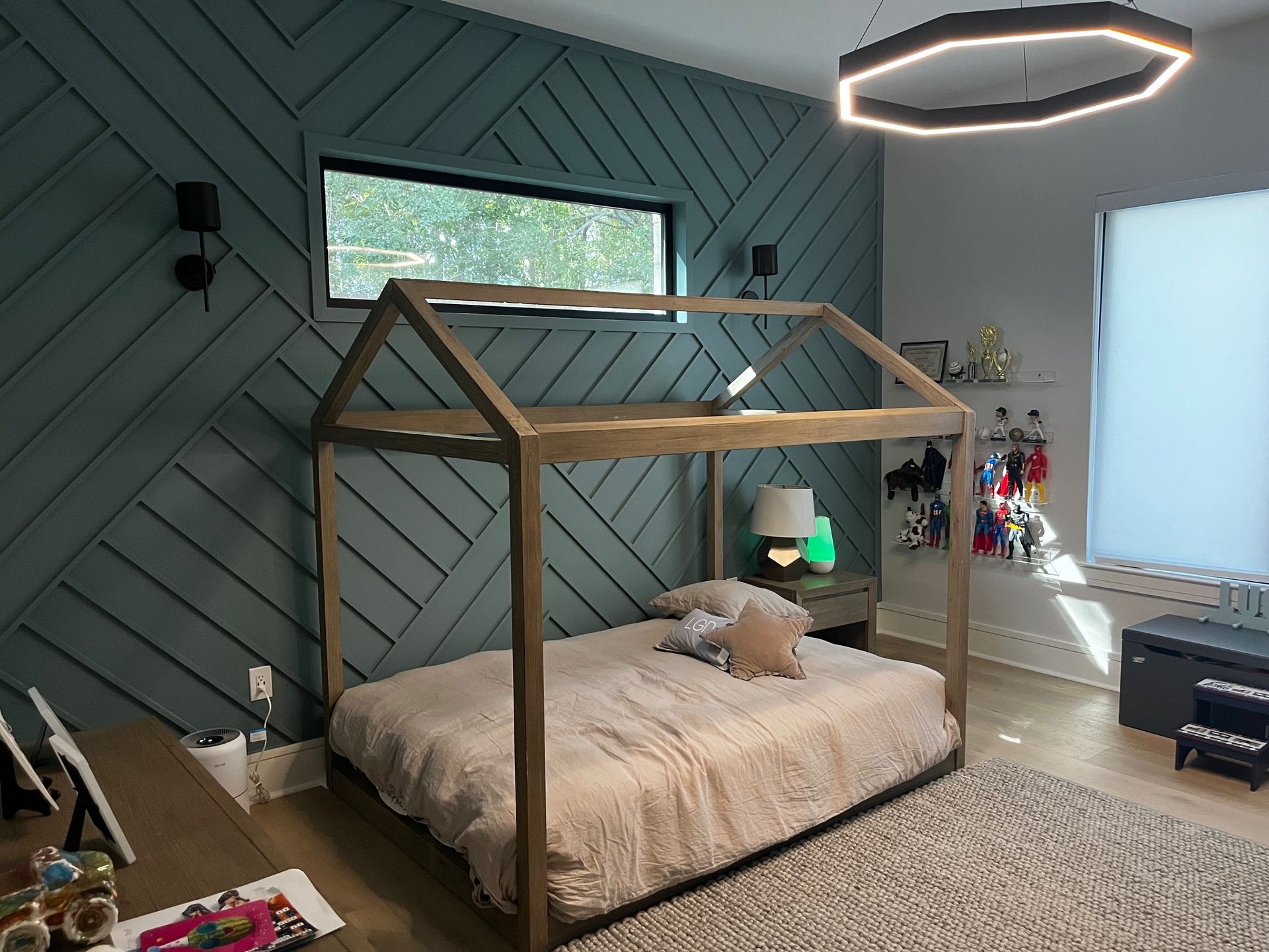 A bedroom with a bed in the shape of a house.