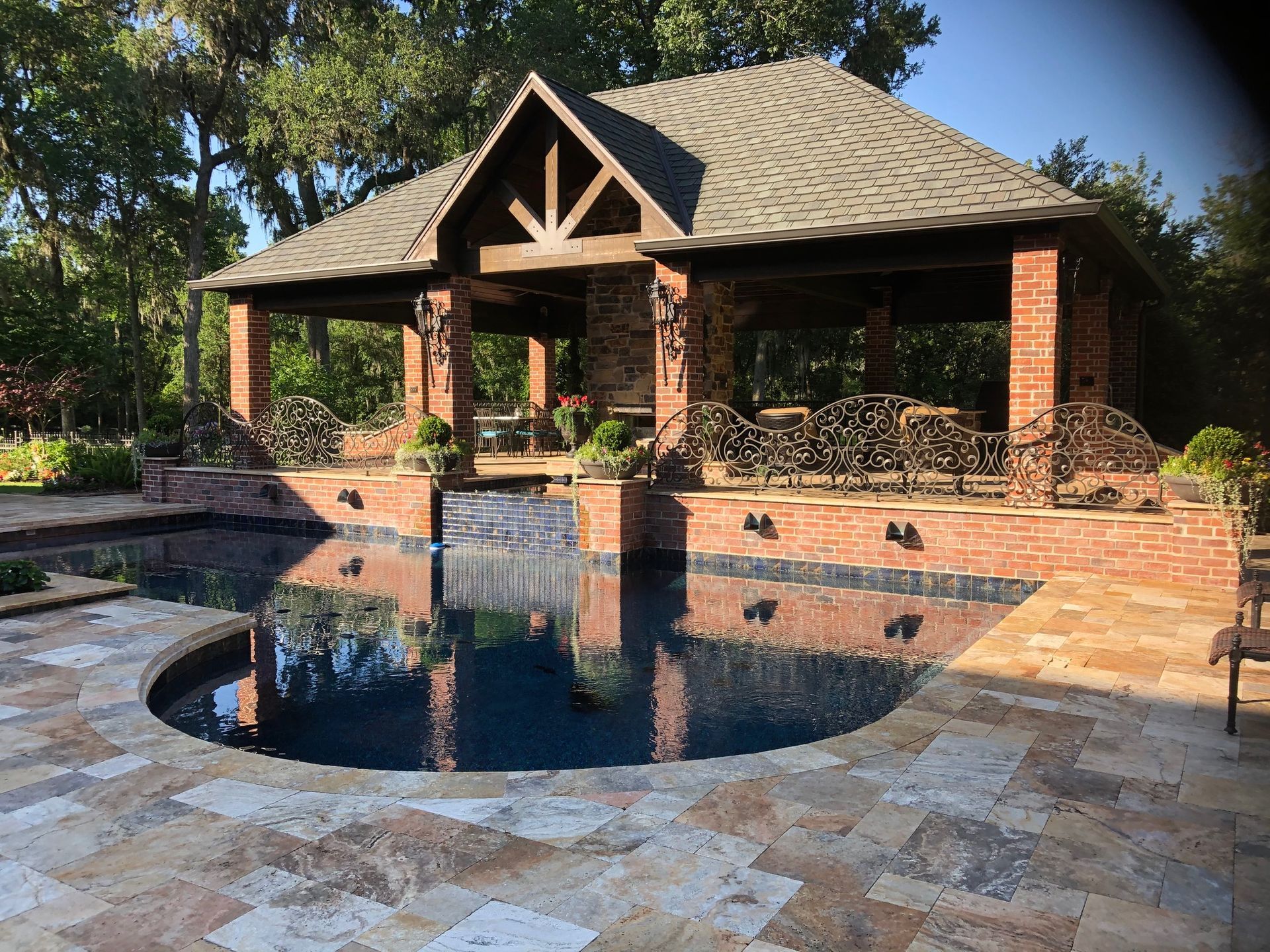A large brick building with a pool in front of it