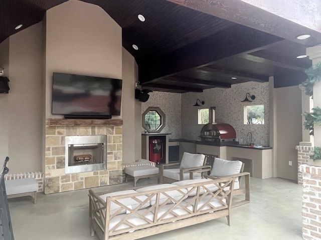 A living room with a fireplace and a flat screen tv