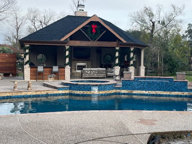A large swimming pool with a gazebo in the background.