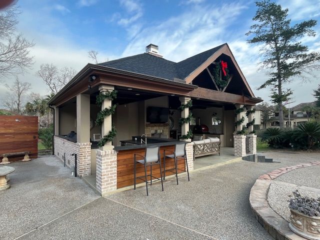 A large house with a bar and stools in front of it