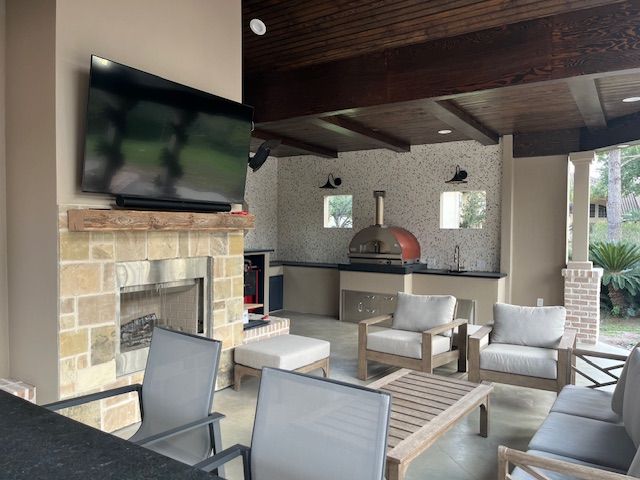 A living room with a fireplace and a flat screen tv