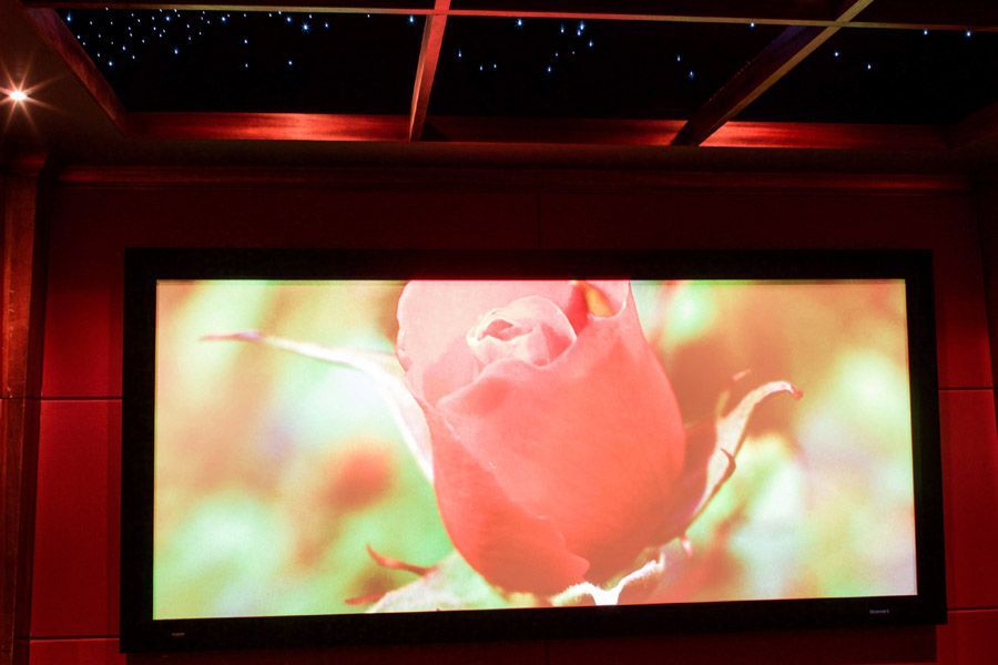A large screen with a picture of a rose on it