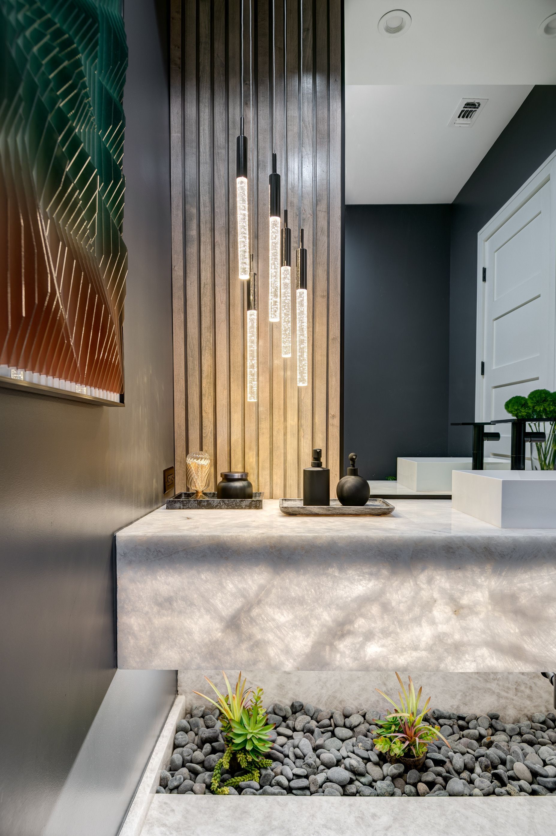 A bathroom with a sink , mirror , and plants.