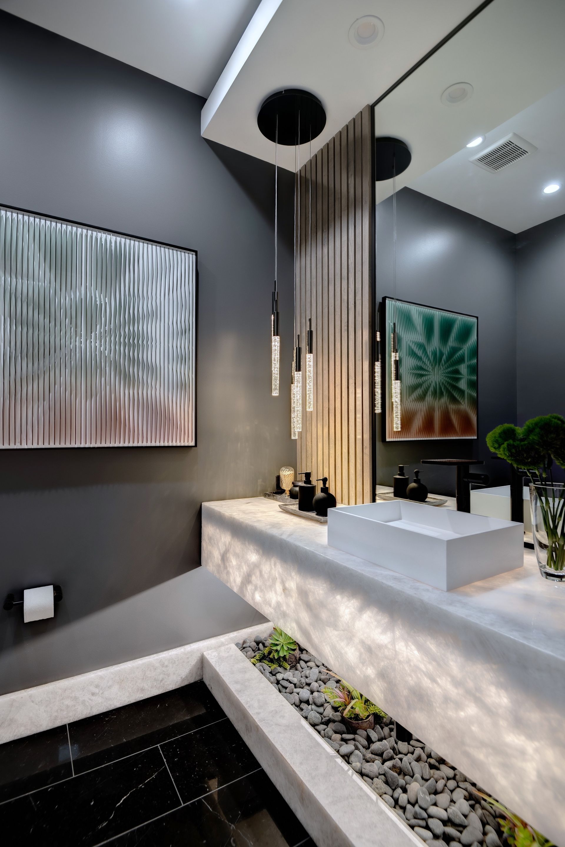 A bathroom with a sink , mirror and painting on the wall.