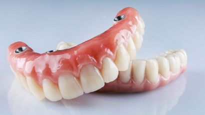A close up of a full denture on a table. — Burleigh Heads Denture Clinic Gold Coast in Burleigh Heads, QLD