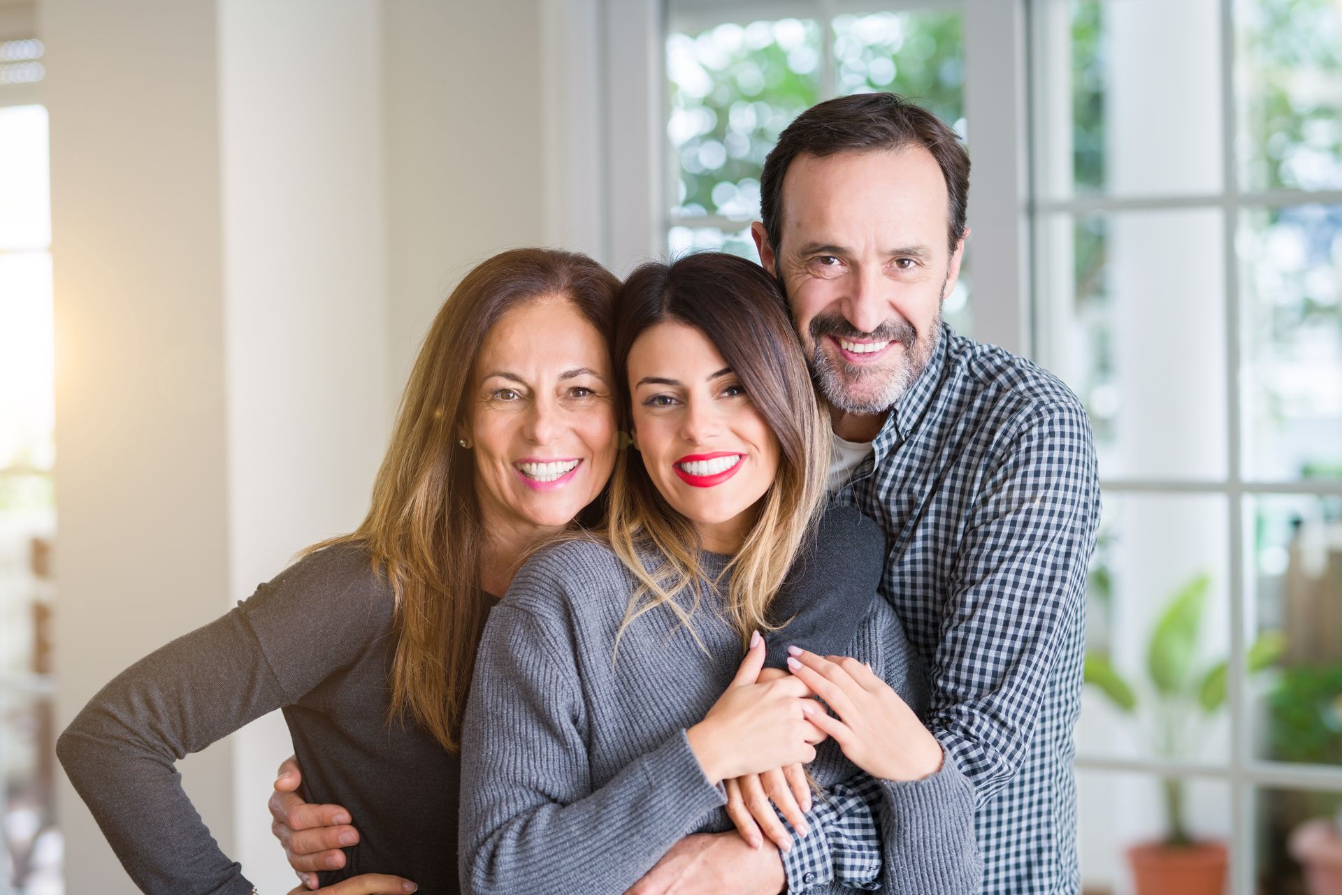A family is posing for a picture together in a living room.