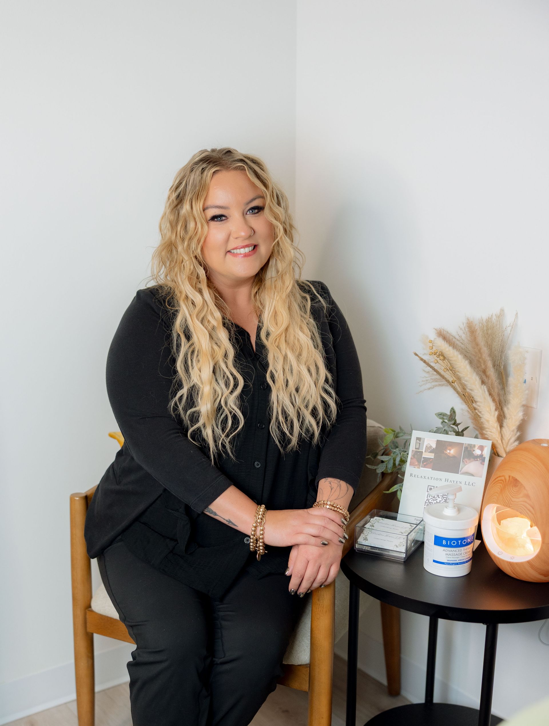 A woman in a black shirt is smiling for the camera.