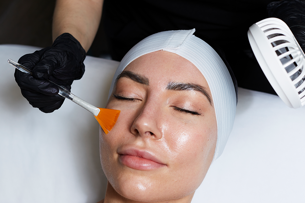 A woman is getting a facial treatment at a beauty salon.