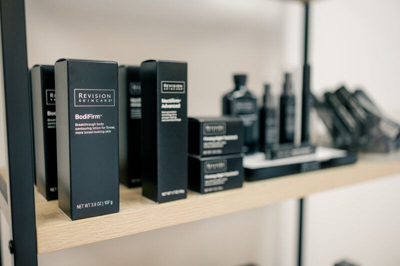 A shelf filled with boxes and bottles of beauty products.