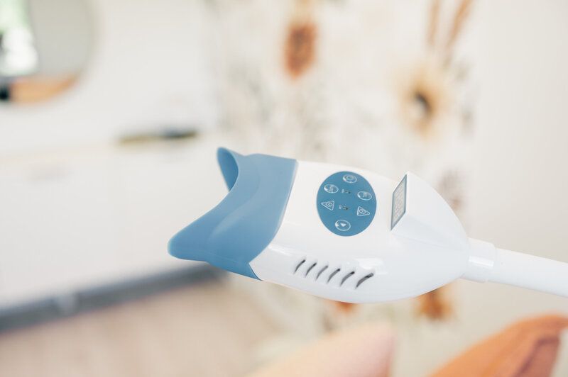 A close up of a tooth whitening device in a dental office.