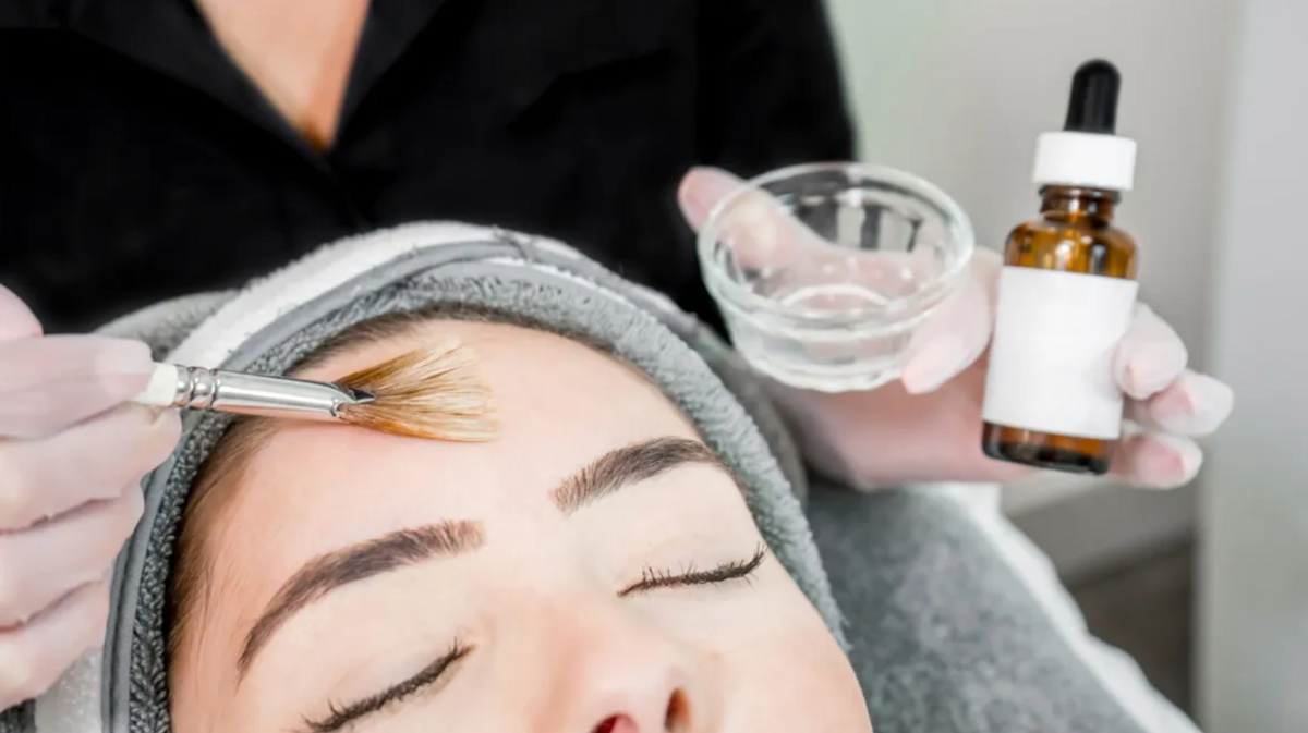 A woman is getting a facial treatment at a beauty salon.