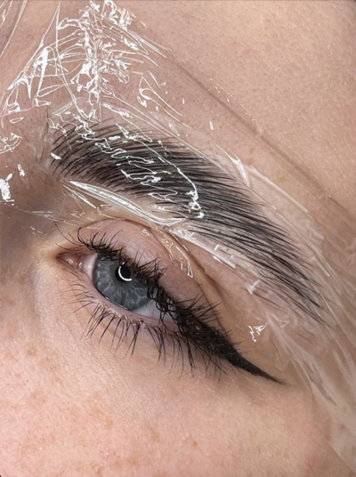 A close up of a woman 's eye with plastic wrap on it.