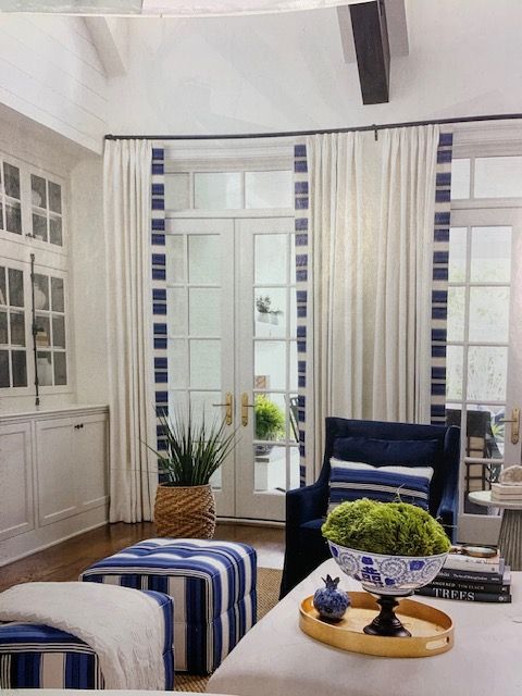 An arched window with a view of trees in a hallway