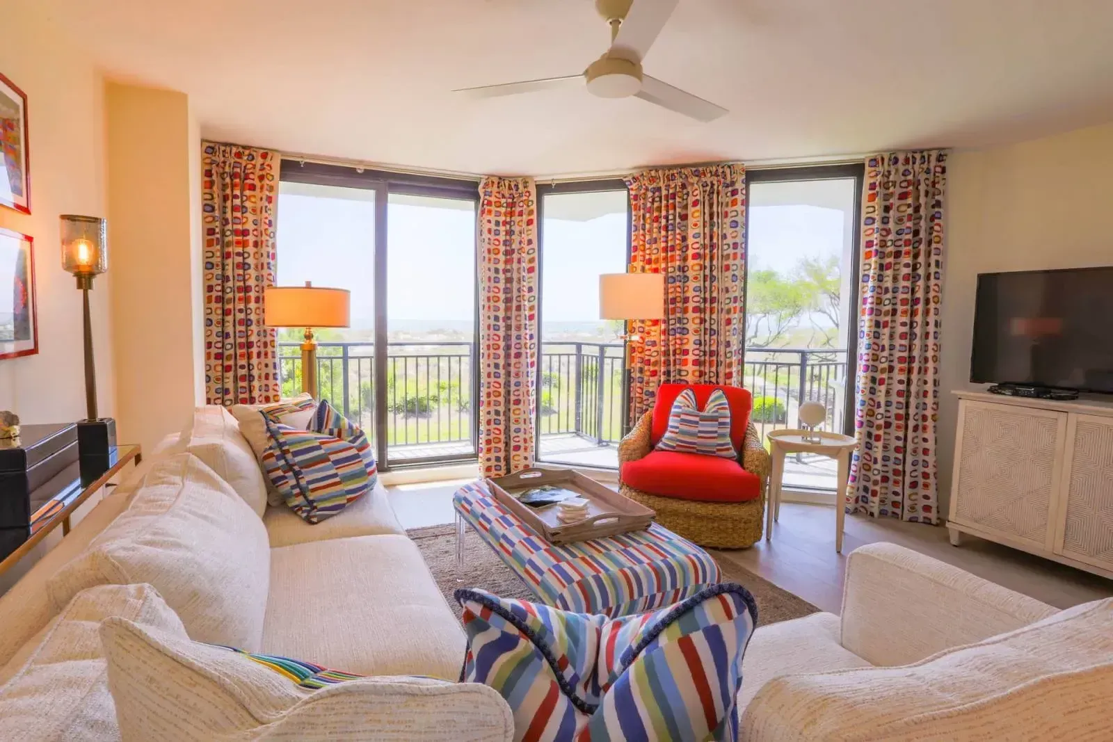 A living room with a couch , chair , coffee table and television.