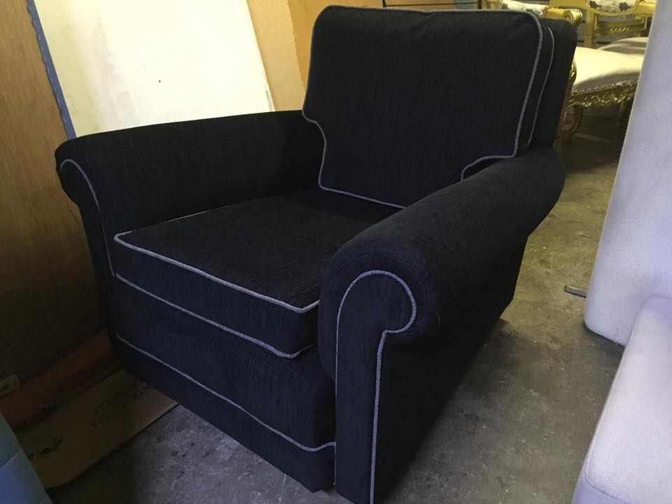 A Black Chair With White Trim Is Sitting In A Room — Aztak Upholstery In Cairns, QLD