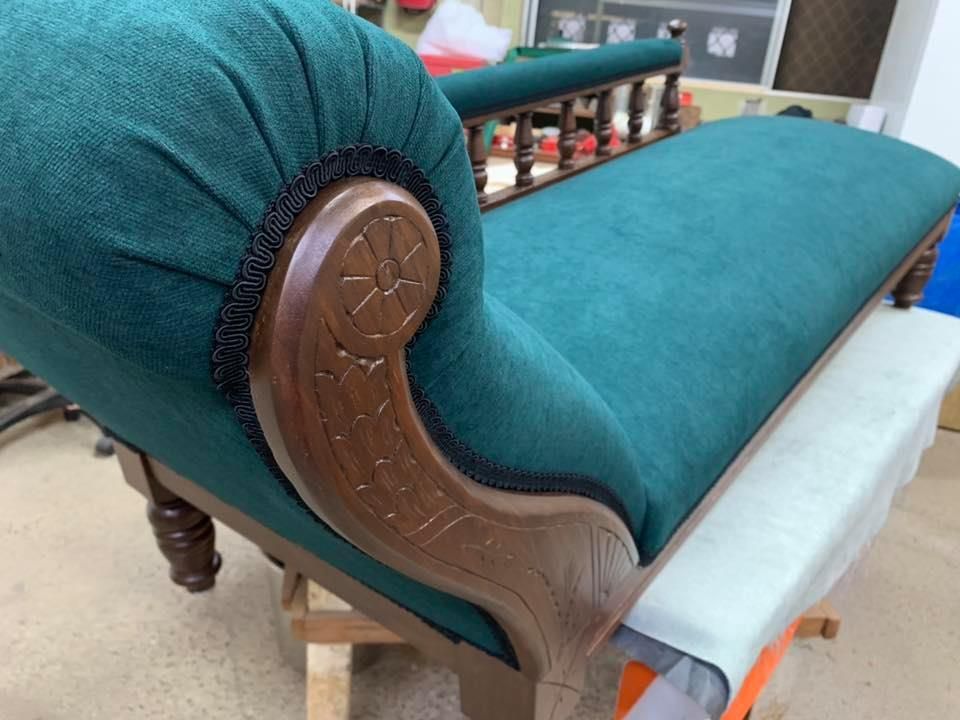 A Green And Blue Couch Is Sitting In A Corner Of A Room — Aztak Upholstery In Manunda, QLD
