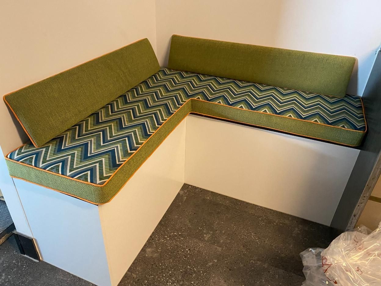 A Corner Bench With Green and Blue Cushions in a Room — Aztak Upholstery In Manunda, QLD