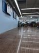 A blurred image of a parking garage with a wooden floor.