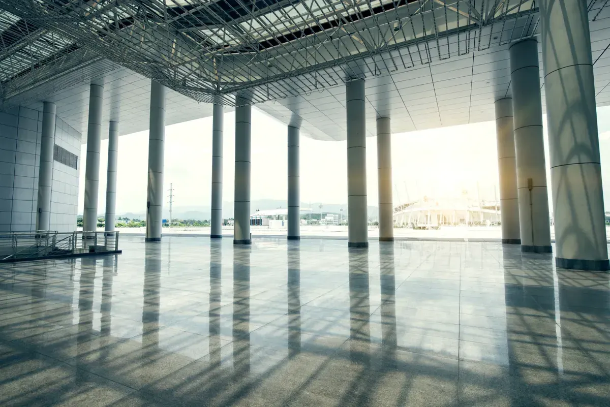 a large empty building with a lot of windows and columns .