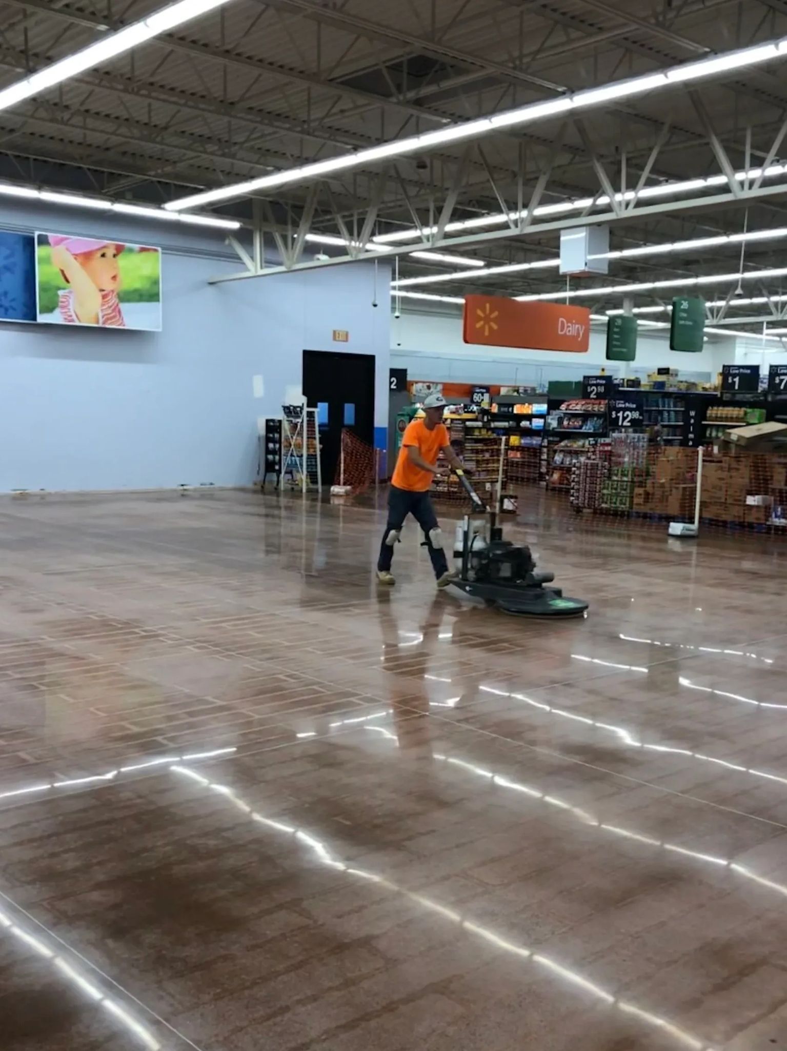 A man is cleaning the floor of a grocery store.