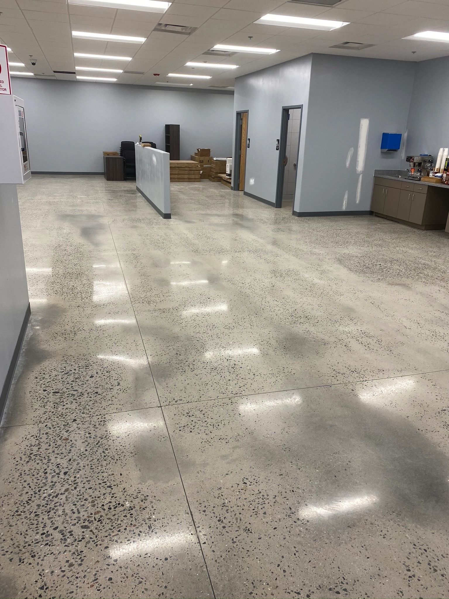 A large empty room with a shiny concrete floor