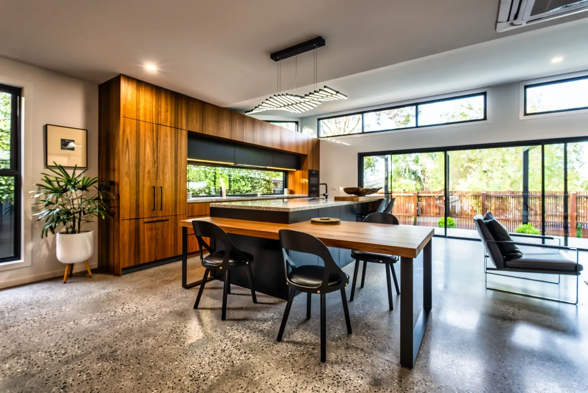 there is a dining table and chairs in the middle of the room .