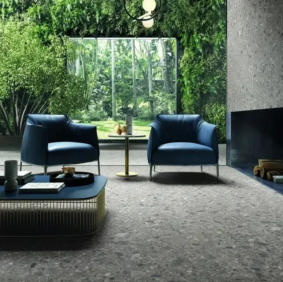 a living room with two blue chairs and a coffee table