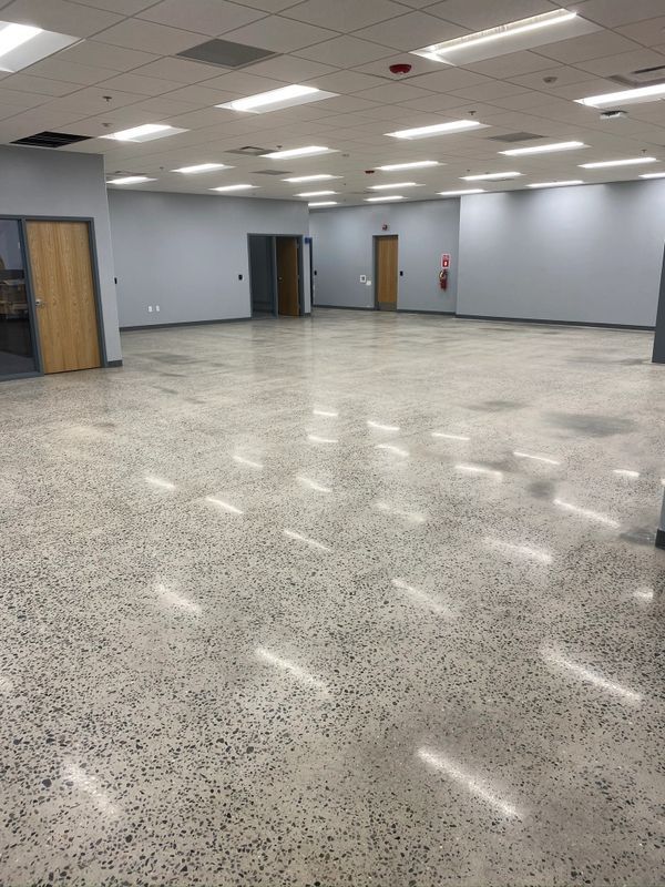 A large empty room with a shiny concrete floor